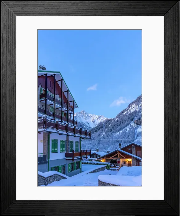 Framed Print : View of chalets and snow covered mountains in Courmayeur before dawn in winter, Courmayeur, Aosta Valley, Italian Alps, Italy