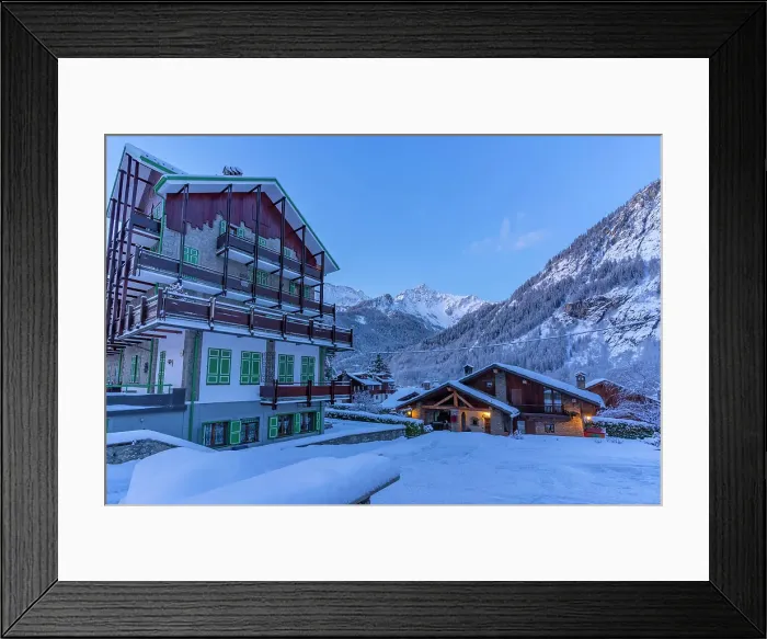 Framed Print : View of chalets and snow covered mountains in Courmayeur before dawn in winter, Courmayeur, Aosta Valley, Italian Alps, Italy