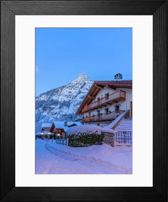 Framed Print : View of chalets and snow covered mountains in Courmayeur before dawn in winter, Courmayeur, Aosta Valley, Italian Alps, Italy