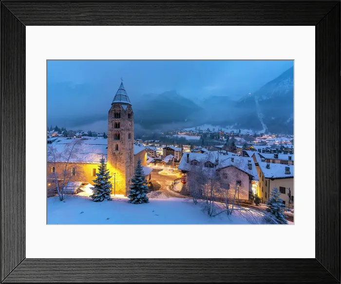Framed Print : Church of Saint Pantalon, snow covered town centre and mountainous background in winter at dusk, Courmayeur, Aosta Valley, Italian Alps, Italy