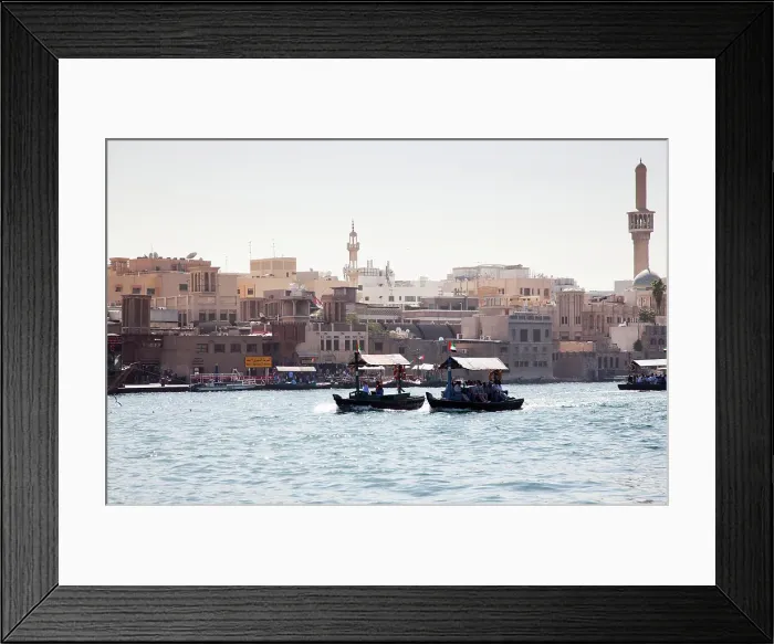 Framed Print : Traditional Abra ferries crossing Dubai Creek which divides the city into two sections of Deira and Bur Dubai, Dubai, United Arab Emirates Framed Print : Traditional Abra ferries crossing Dubai Creek which divides the city into two sections of Deira and Bur Dubai, Dubai, United Arab Emirates