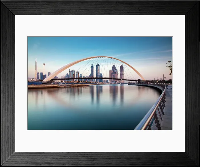 Framed Print : Colorful sunset over Dubai Downtown skyscrapers and newly built Tolerance bridge viewed from Dubai water canal, Dubai, United Arab Emirates Framed Print : Colorful sunset over Dubai Downtown skyscrapers and newly built Tolerance bridge viewed from Dubai water canal, Dubai, United Arab Emirates