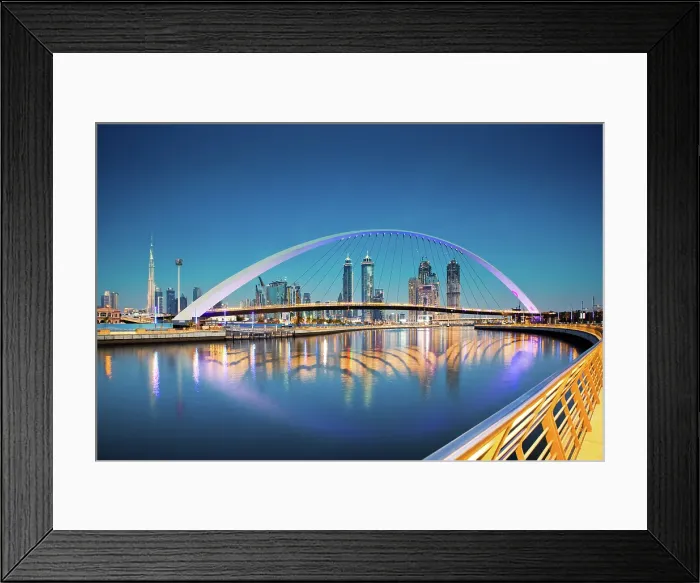 Framed Print : Colorful sunset over Dubai Downtown skyscrapers and newly built Tolerance Bridge seen from the Dubai water canal, Dubai, United Arab Emirates Framed Print : Colorful sunset over Dubai Downtown skyscrapers and newly built Tolerance Bridge seen from the Dubai water canal, Dubai, United Arab Emirates