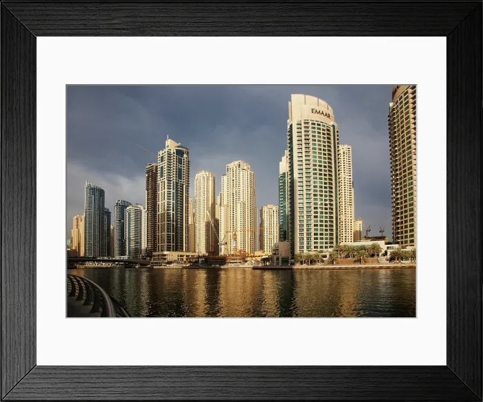 Framed Print : View of modern skyscrapers shining in sunrise lights in Dubai Marina in Dubai, United Arab Emirates Framed Print : View of modern skyscrapers shining in sunrise lights in Dubai Marina in Dubai, United Arab Emirates