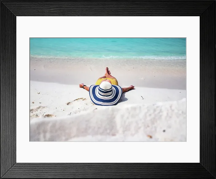 Framed Print : Woman with straw hat sunbathing on tropical beach, The Maldives, Indian Ocean