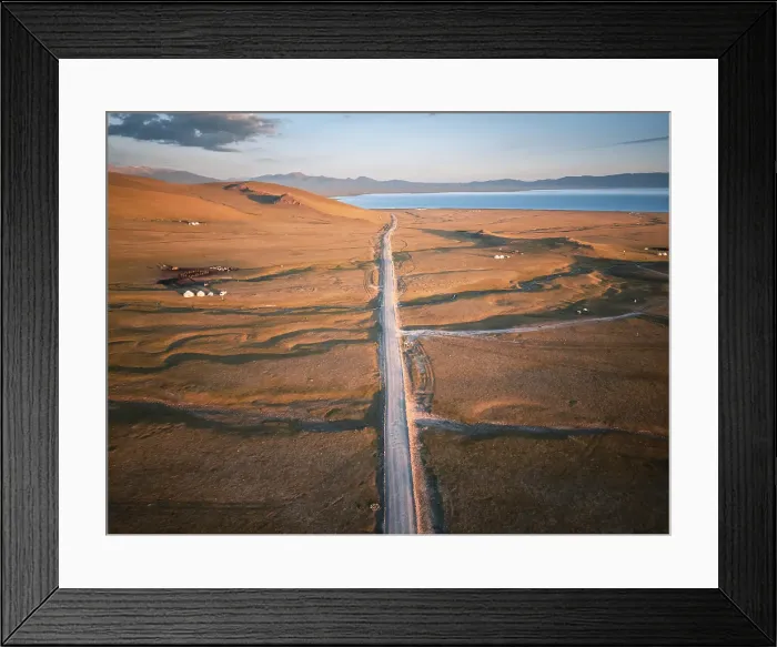 Framed Print : A long, dusty road stretches across the vast landscape of Song Kol Lake area, Kyrgyzstan Framed Print : A long, dusty road stretches across the vast landscape of Song Kol Lake area, Kyrgyzstan
