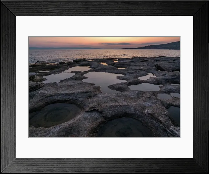 Framed Print : Natural holes in the rocks full of water at sunset, with sea in the background, Greece Framed Print : Natural holes in the rocks full of water at sunset, with sea in the background, Greece