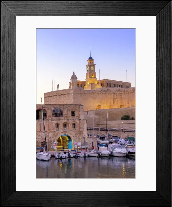 Framed Print : The Old Dock Buildings at Bormla Waterfront with Fort St. Michael Clock Tower in the background at dusk, Cospicua, Malta Framed Print : The Old Dock Buildings at Bormla Waterfront with Fort St. Michael Clock Tower in the background at dusk, Cospicua, Malta