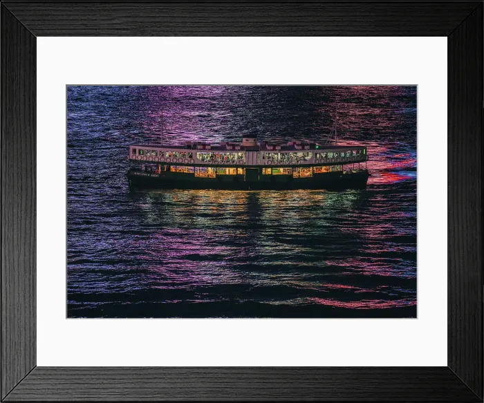 Framed Print : The Star Ferry at night with the reflections of the buildings in the harbour water in Hong Kong, China Framed Print : The Star Ferry at night with the reflections of the buildings in the harbour water in Hong Kong, China
