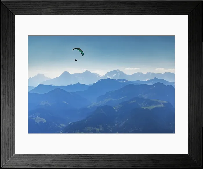 Framed Print : Paraglider flying over Kander Valley with Jungfrau, Monch and Eiger mountains in the background, Canton of Bern, Switzerland Framed Print : Paraglider flying over Kander Valley with Jungfrau, Monch and Eiger mountains in the background, Canton of Bern, Switzerland