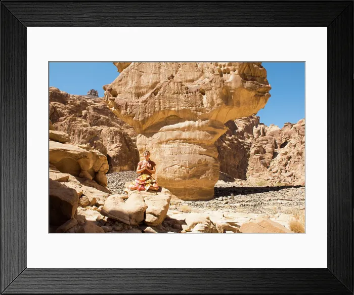 Framed Print : Woman practising yoga poses among sandstone rock formation in the desert canyons of the Ashar Valley, Medina Province, Saudi Arabia Framed Print : Woman practising yoga poses among sandstone rock formation in the desert canyons of the Ashar Valley, Medina Province, Saudi Arabia