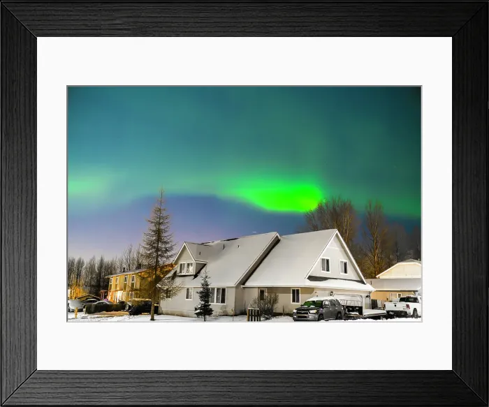 Framed Print : Northern lights (Aurora borealis) illuminate the night sky along the horizon behind mountains near Anchorage, Alaska, United States Of America