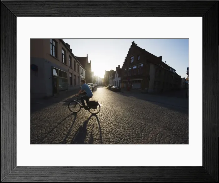 Framed Print : Sunset and shadow of a cyclist on cobbled street, old town, UNESCO World Heritage Site Framed Print : Sunset and shadow of a cyclist on cobbled street, old town, UNESCO World Heritage Site