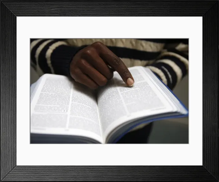 Framed Print : African man reading the Bible in a church, Paris, France, Europe Framed Print : African man reading the Bible in a church, Paris, France, Europe