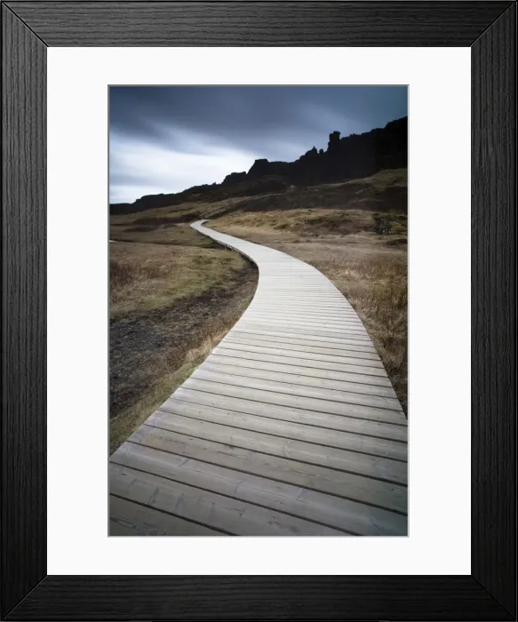 Framed Print : Boardwalk meandering towards rugged cliffs and stormy sky at Thingvellir National Park near Reykjavik, Iceland Framed Print : Boardwalk meandering towards rugged cliffs and stormy sky at Thingvellir National Park near Reykjavik, Iceland