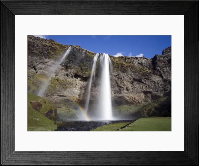 Framed Print : Seljalandsfoss Waterfall tumbling over towering cliffs in bright sunlight with rainbow at the base of the waterfall, near Hella, Southern Iceland, Iceland Framed Print : Seljalandsfoss Waterfall tumbling over towering cliffs in bright sunlight with rainbow at the base of the waterfall, near Hella, Southern Iceland, Iceland