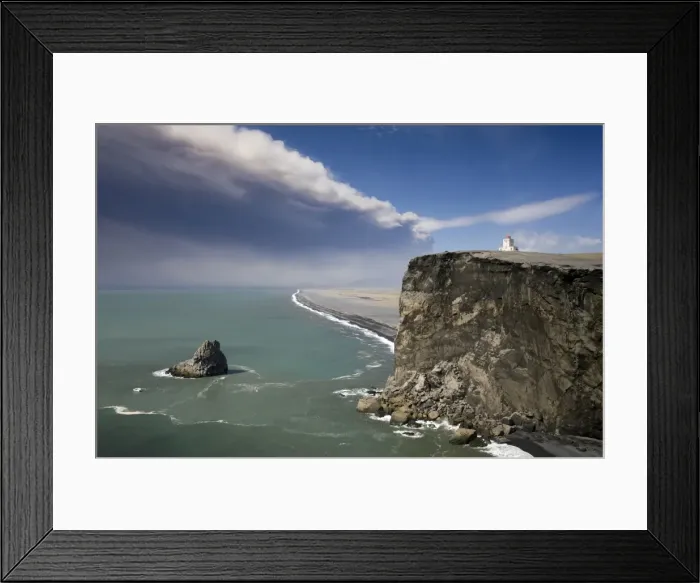 Framed Print : Headland with lighthouse at Dyrholaey looking towards a black volcanic sand beach stretching 15 miles into the distance and the ash plume of the Eyjafjallajokull eruption, near Vik i Myrdal, southern area, Iceland Framed Print : Headland with lighthouse at Dyrholaey looking towards a black volcanic sand beach stretching 15 miles into the distance and the ash plume of the Eyjafjallajokull eruption, near Vik i Myrdal, southern area, Iceland
