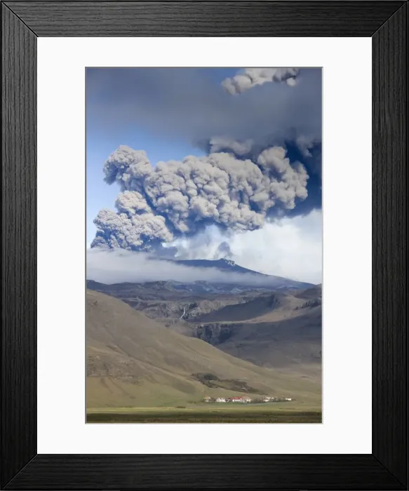 Framed Print : Houses at foot of mountains with the ash plume of the Eyjafjallajokull eruption in the distance Framed Print : Houses at foot of mountains with the ash plume of the Eyjafjallajokull eruption in the distance