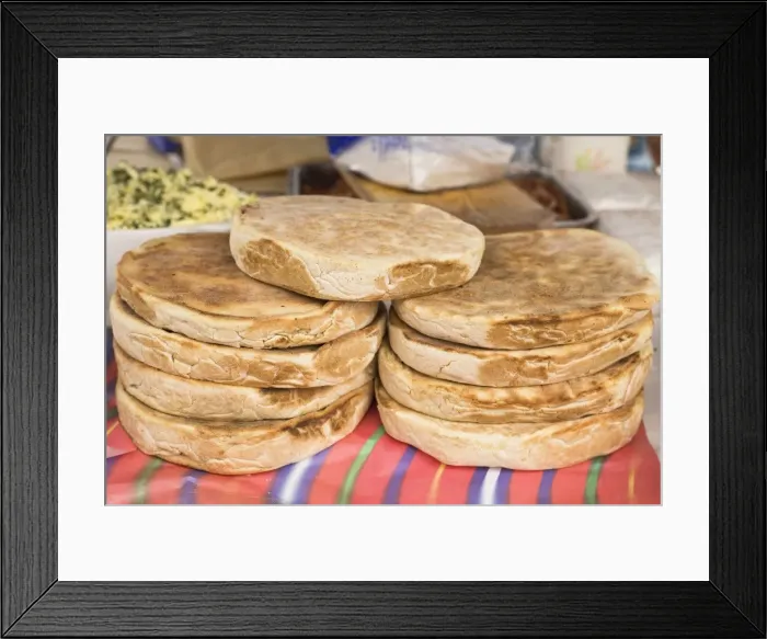 Framed Print : Traditional Madeiran flat bread is cooked and served at a stall in Funchal