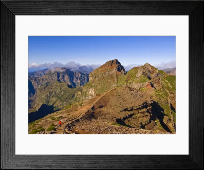 Framed Print : Hiker in red jacket walking down new footpath across the volcanic landscape towards Madeiras third highest peak, Pico do Arieiro, Madeira Framed Print : Hiker in red jacket walking down new footpath across the volcanic landscape towards Madeiras third highest peak, Pico do Arieiro, Madeira