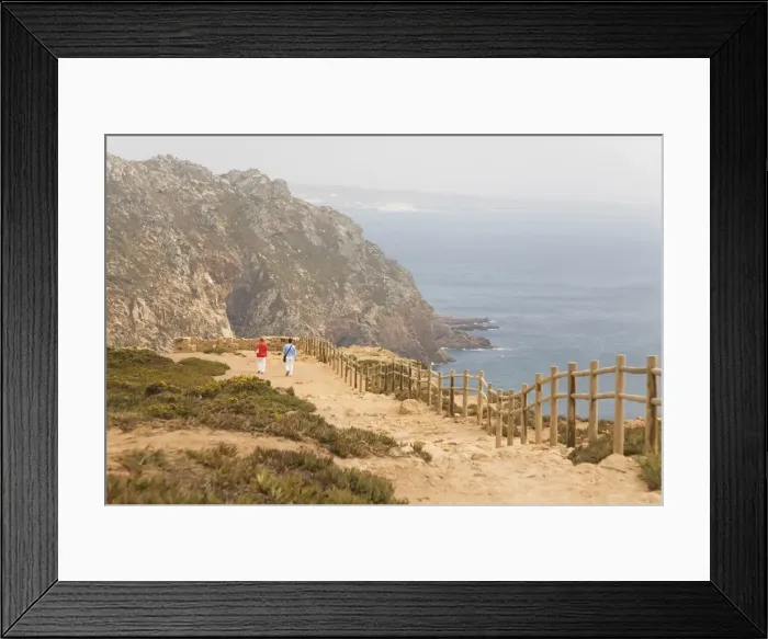 Framed Print : People walk along cliffs overlooking the Atlantic Ocean at Europes most westerly point at Cabo da Roca Framed Print : People walk along cliffs overlooking the Atlantic Ocean at Europes most westerly point at Cabo da Roca