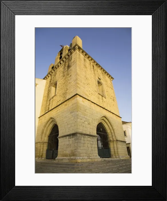 Framed Print : The fortress like stone tower of medieval Faro Cathedral (Largo da Se) in Faro Framed Print : The fortress like stone tower of medieval Faro Cathedral (Largo da Se) in Faro