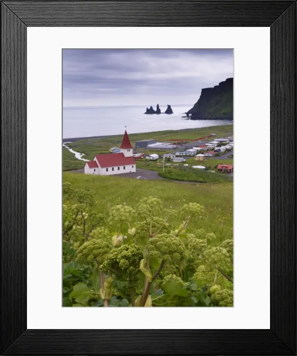 Framed Print : Church and village of Vik (Vik a Myrdal) and Reynisdrangar sea stacks in the distance Framed Print : Church and village of Vik (Vik a Myrdal) and Reynisdrangar sea stacks in the distance