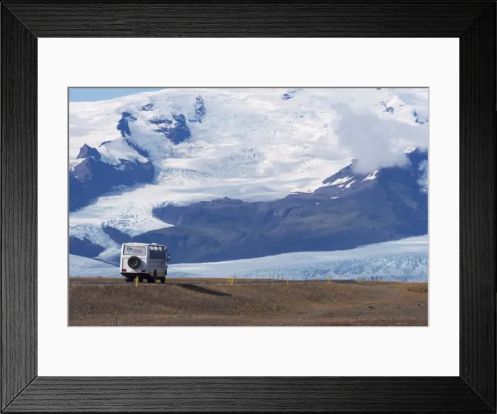 Framed Print : A tourist bus on the ring road (Route 1) beneath the huge mass of Oraefajokull Framed Print : A tourist bus on the ring road (Route 1) beneath the huge mass of Oraefajokull