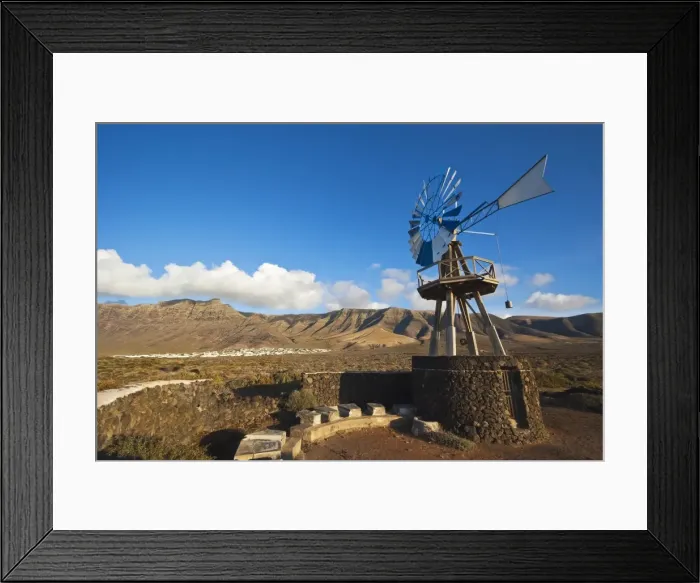 Framed Print : Traditional wind pump with 600m volcanic cliffs of the Risco de Famara rising over desert landscape near Famara in the north west of the island, Famara, Lanzarote, Canary Islands, Spain, Atlantic Framed Print : Traditional wind pump with 600m volcanic cliffs of the Risco de Famara rising over desert landscape near Famara in the north west of the island, Famara, Lanzarote, Canary Islands, Spain, Atlantic
