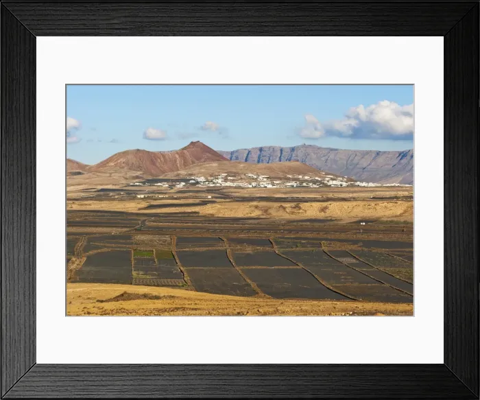 Framed Print : View across black volcanic cinder fields to the town of Soo and the Risco de Famara range with the highest point on the island at Penas del Cache radar site, Soo, Lanzarote, Canary Islands, Spain, Atlantic Framed Print : View across black volcanic cinder fields to the town of Soo and the Risco de Famara range with the highest point on the island at Penas del Cache radar site, Soo, Lanzarote, Canary Islands, Spain, Atlantic