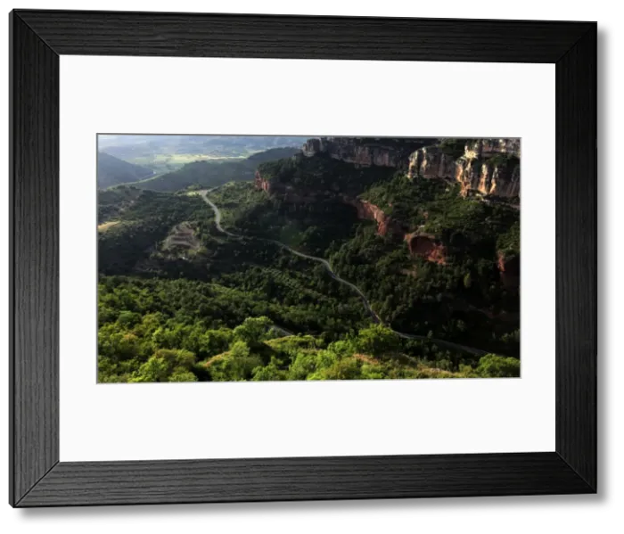 Framed Print : View across the limestone ravine beaneath the medieval village of Siurana Framed Print : View across the limestone ravine beaneath the medieval village of Siurana