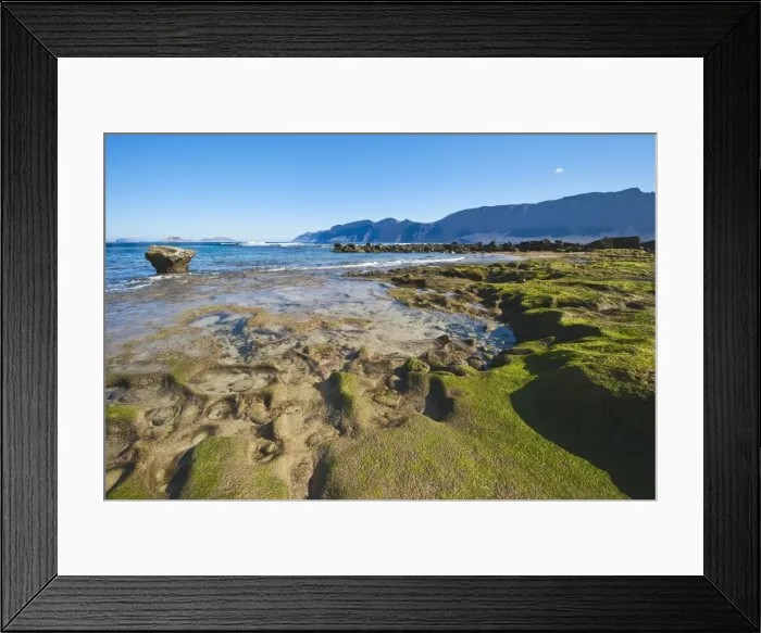 Framed Print : Spectacular 600m volcanic cliffs of the Risco de Famara and Graciosa Island backdrop to the rocky southern shore of the bay at Famara in the north west, Lanzarote, Canary Islands, Spain, Atlantic Framed Print : Spectacular 600m volcanic cliffs of the Risco de Famara and Graciosa Island backdrop to the rocky southern shore of the bay at Famara in the north west, Lanzarote, Canary Islands, Spain, Atlantic