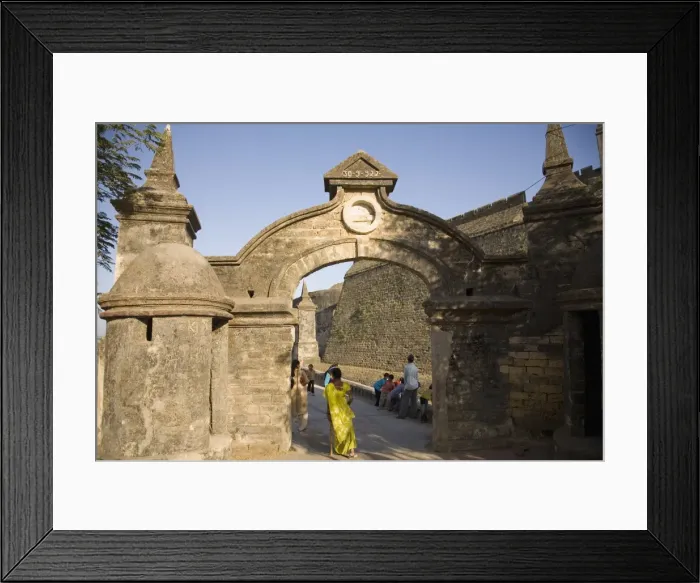Framed Print : An Indian woman in a sari walks through the gate leading to the Fortress in Diu