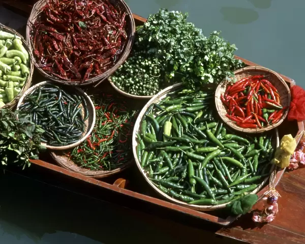 An assortment of chillies, a staple ingredient of Thai cooking, on sale on a boat in a floating market in Thailand, Southeast