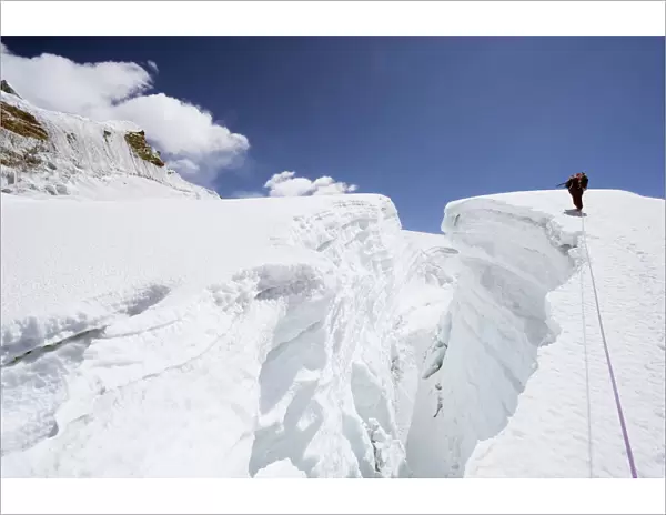 Mountain guide traversing a crevasse, Island Peak, 6189m, Solu Khumbu Everest Region