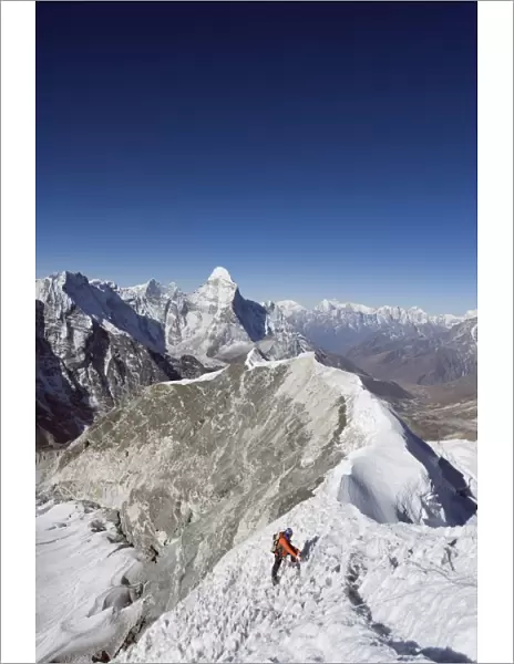 Climber on summit ridge of Island Peak, 6189m, Ama Dablam, 6812m, Solu Khumbu Everest Region