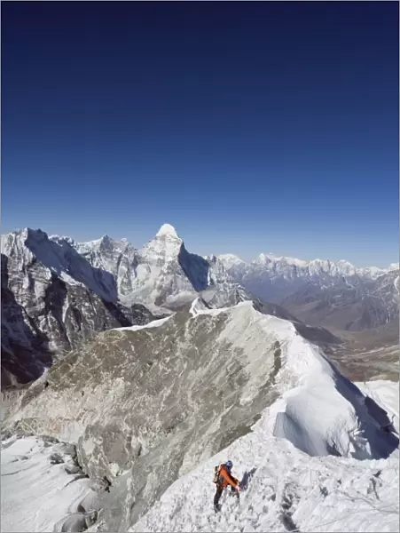 Climber on summit ridge of Island Peak, 6189m, Ama Dablam, 6812m, Solu Khumbu Everest Region