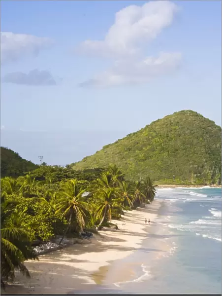 Two women walking on the sandy beach on Long Bay, Tortola, British Virgin Islands