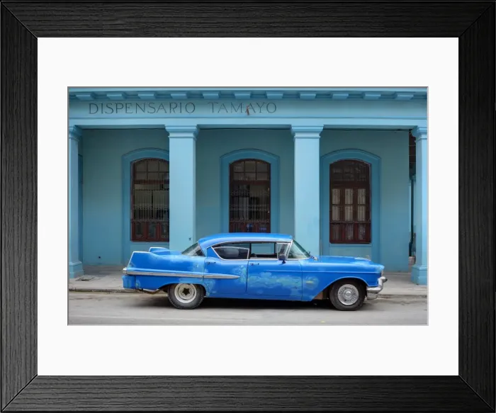 Framed Print : Old blue American car with body repairs parked in front of blue dispensary Framed Print : Old blue American car with body repairs parked in front of blue dispensary