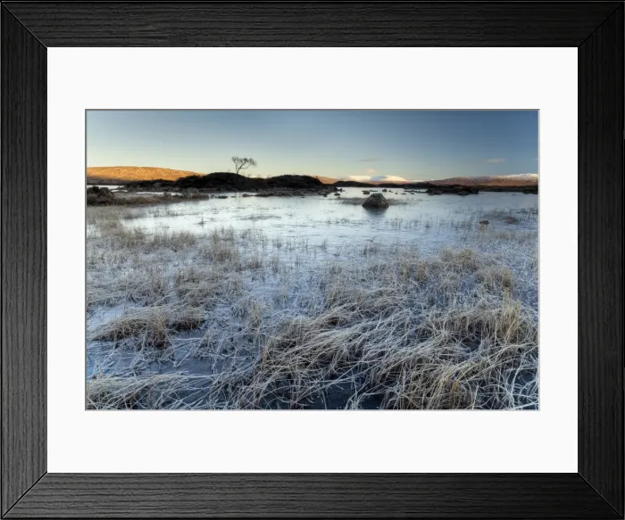 Framed Print : Winter view across frozen Lochain na h Achlaise at dawn, first light catching distant mountains Framed Print : Winter view across frozen Lochain na h Achlaise at dawn, first light catching distant mountains