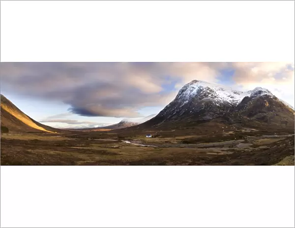 Winter panoramic view of Rannoch Moor showing lone whitewashed cottage on the bank of a river