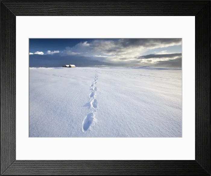 Framed Print : Footsteps in freshly-fallen snow leading off into distance towards dramatic winter sky Framed Print : Footsteps in freshly-fallen snow leading off into distance towards dramatic winter sky