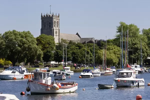 Christchurch Priory and pleasure boats on the River Stour, Dorset, England