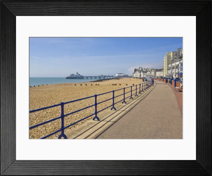 Framed Print : Pebble beach and groynes, hotels on the seafront promenade, Eastbourne pier in the distance Framed Print : Pebble beach and groynes, hotels on the seafront promenade, Eastbourne pier in the distance