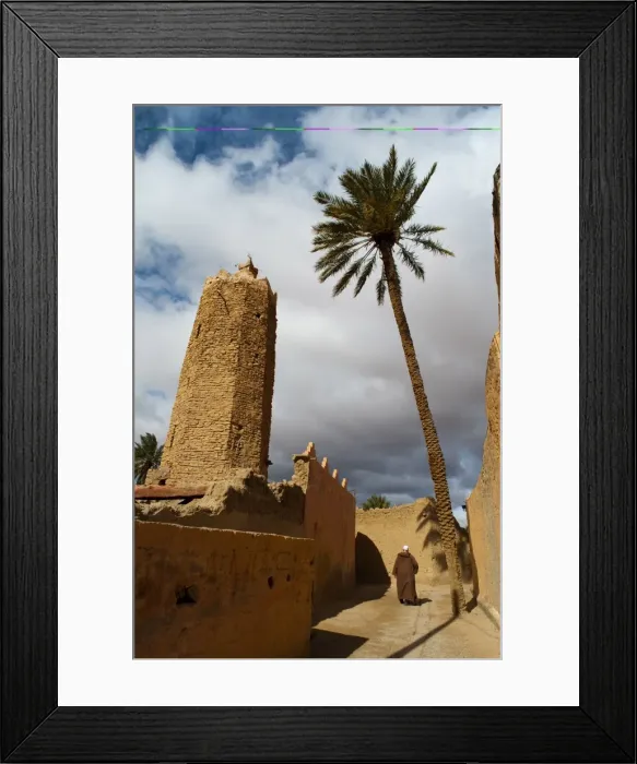 Framed Print : Moroccan man, stone minaret of Sawmann Al-Hajaria, Figuig, province of Figuig Framed Print : Moroccan man, stone minaret of Sawmann Al-Hajaria, Figuig, province of Figuig