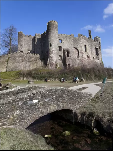 Stone footbridge in front of Laugharne Castle, Carmarthenshire, Wales, United Kingdom