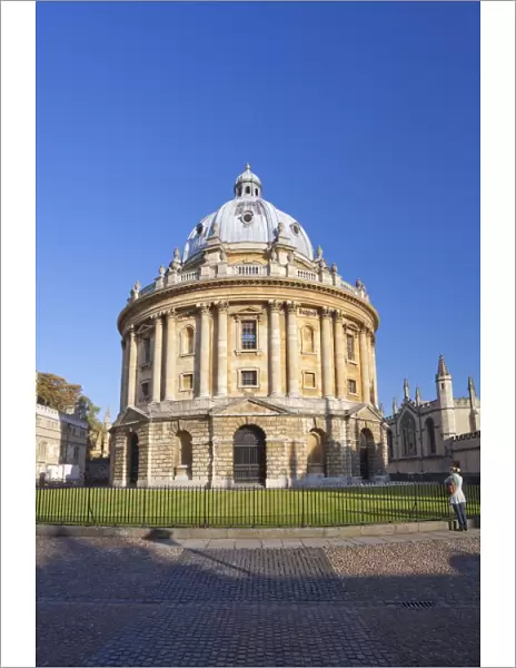Student stands in front of Radcliffe Camera, Oxford University, Oxford