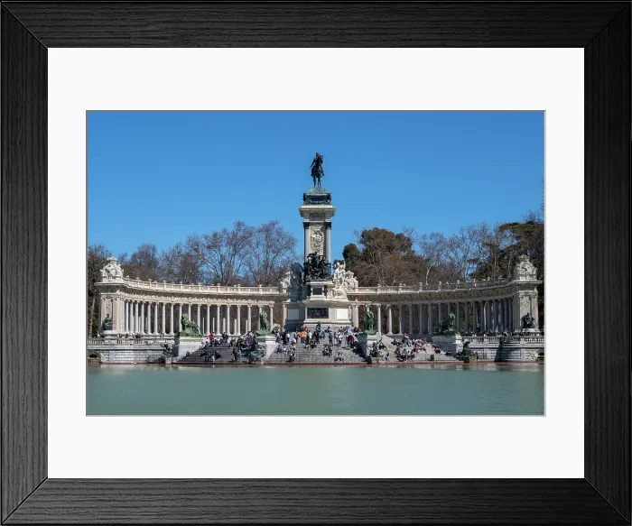 Framed Print : People relaxing in front of the Monument to Alfonso XII and boating lake in Retiro Park in the heart of the capital city of Madrid, Spain Framed Print : People relaxing in front of the Monument to Alfonso XII and boating lake in Retiro Park in the heart of the capital city of Madrid, Spain