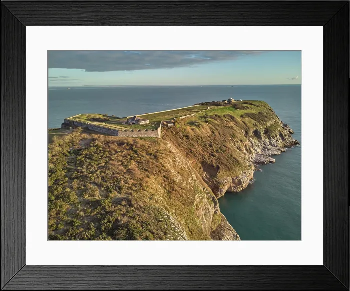 Framed Print : An early morning view of the cliffs at Berry Head, the southernmost point of Torbay, with one of two Napoleonic era forts on the headland, at Brixham, Torbay, Devon, Great Britain
