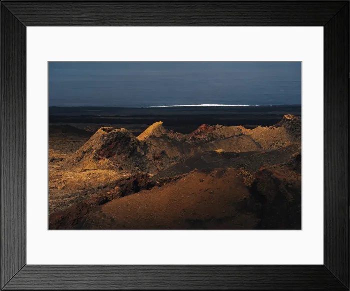 Framed Print : view of Volcanoes and the Volcanic landscape with the Atlantic Ocean in the Timanfaya national park in Lanzarote in the Canary Islands, Spain Framed Print : view of Volcanoes and the Volcanic landscape with the Atlantic Ocean in the Timanfaya national park in Lanzarote in the Canary Islands, Spain